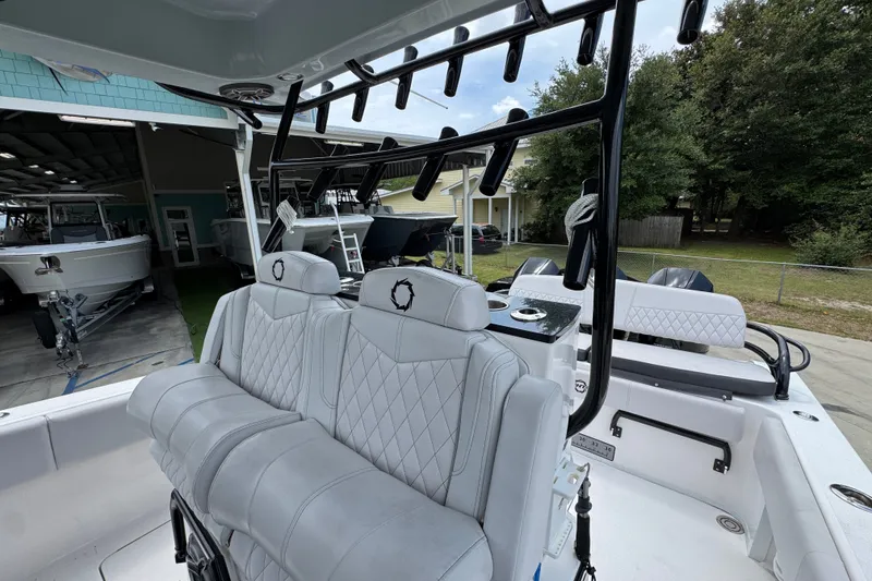 Slide: The Image of 2024 Fountain 34 Tournament Edition boat interior with white seating and rod holders. - 32