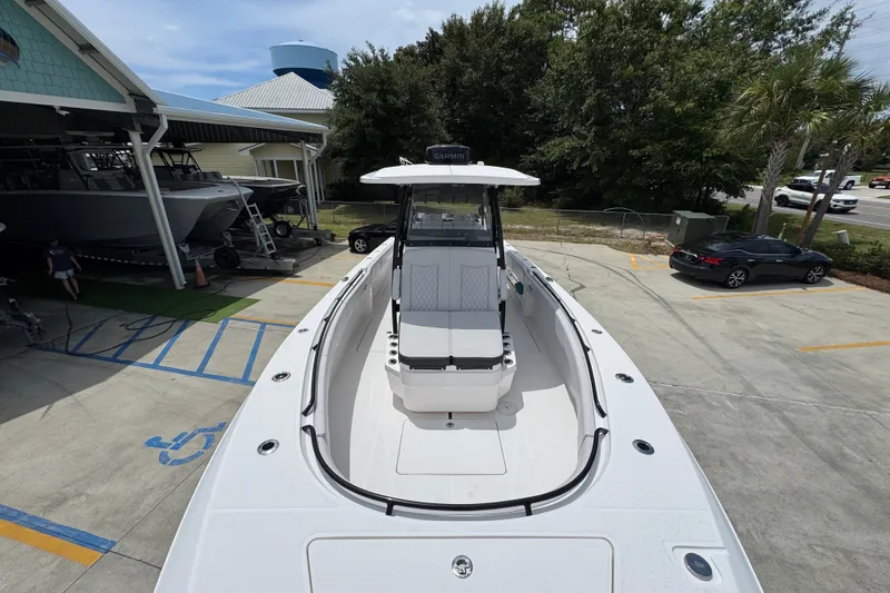 Slide: The Image of 2024 Fountain 34 Tournament Edition boat in a marina, showcasing sleek design and spacious deck. - 26