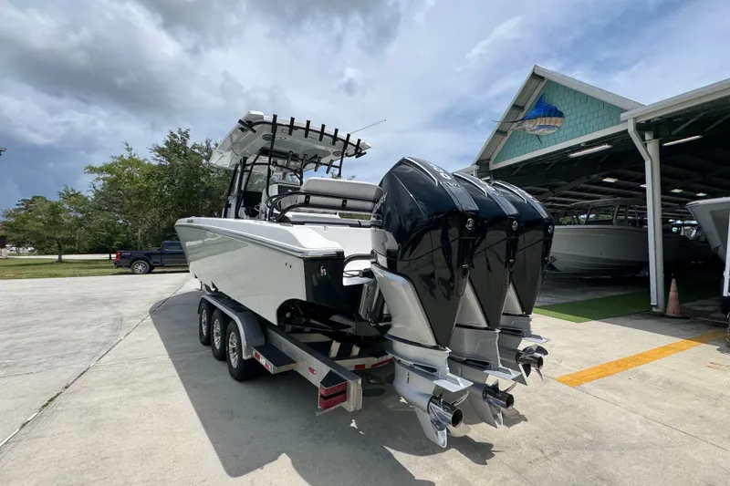 Slide: The Image of 2024 Fountain 34 Tournament Edition boat with triple engines on a trailer. - 19