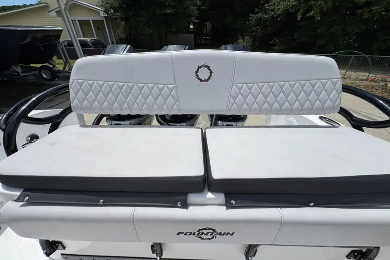 Slide: The Image of 2024 Fountain 34 Tournament Edition boat seating with diamond-pattern upholstery and logo. - 44