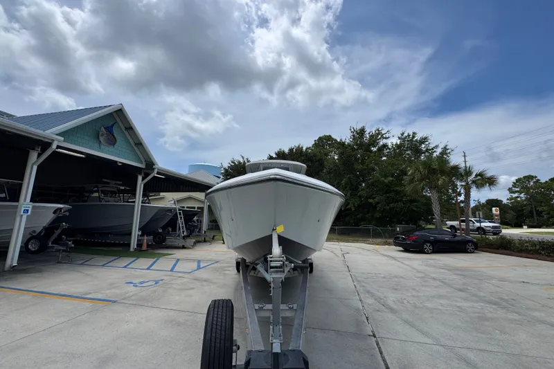 Slide: The Image of 2024 Fountain 34 Tournament Edition boat on trailer in parking lot under cloudy sky. - 7