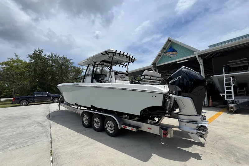 Slide: The Image of 2024 Fountain 34 Tournament Edition boat on trailer, parked outside a marina. - 20