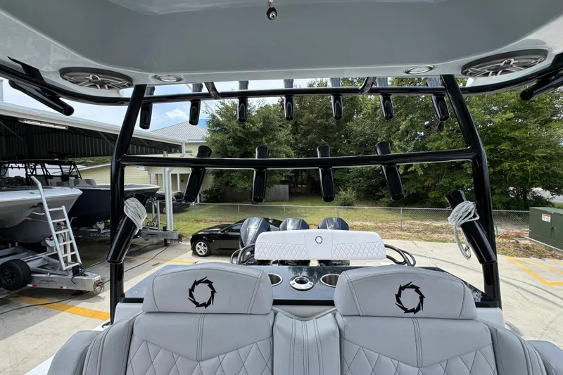 Slide: The Image of 2024 Fountain 34 Tournament Edition boat interior with rod holders and seating. - 34