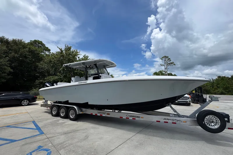 Slide: The Image of 2024 Fountain 34 Tournament Edition boat on trailer under cloudy sky. - 10