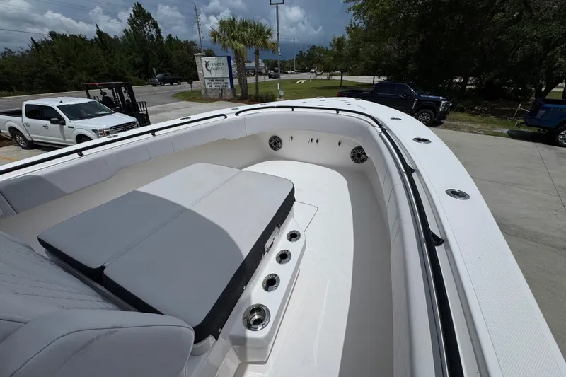 Slide: The Image of 2024 Fountain 34 Tournament Edition boat interior with cushioned seating and cup holders. - 21