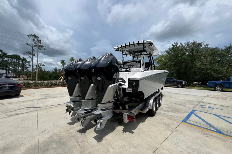 Slide: The Image of 2024 Fountain 34 Tournament Edition boat with triple outboard engines on a trailer. - 15