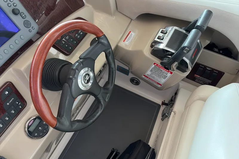 Slide: The Image of Steering wheel and controls of a 2007 Sea Ray 290 Sundancer boat. - 21