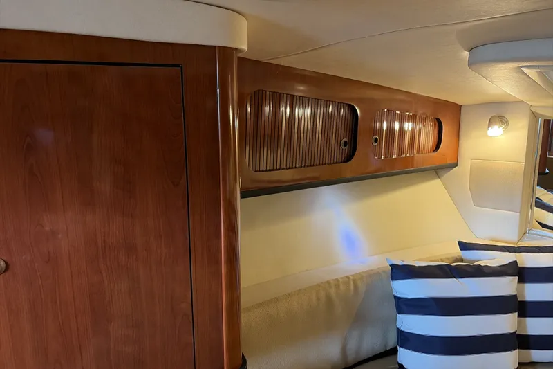 Slide: The Image of Interior of 2007 Sea Ray 290 Sundancer with wood cabinetry and striped cushions. - 42