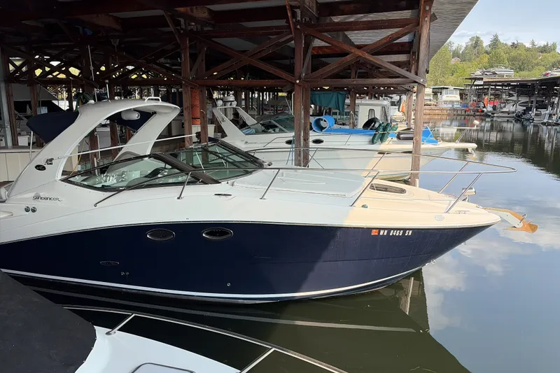 The Image of 2007 Sea Ray 290 Sundancer docked in a marina under a wooden shelter. - 1