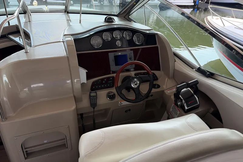 Slide: The Image of 2007 Sea Ray 290 Sundancer helm with steering wheel, gauges, and navigation equipment. - 18