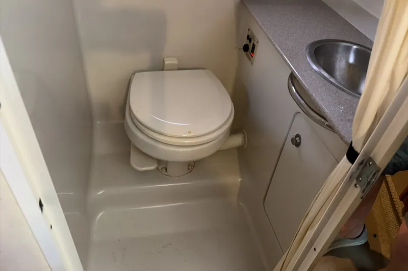 Slide: The Image of 2007 Sea Ray 290 Sundancer bathroom with toilet and sink. - 33