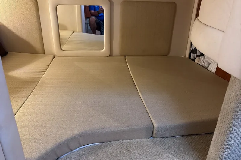 Slide: The Image of Interior cabin of 2007 Sea Ray 290 Sundancer with beige cushions and mirror. - 28