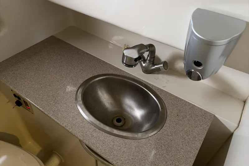 Slide: The Image of 2007 Sea Ray 290 Sundancer bathroom sink with faucet and soap dispenser. - 34