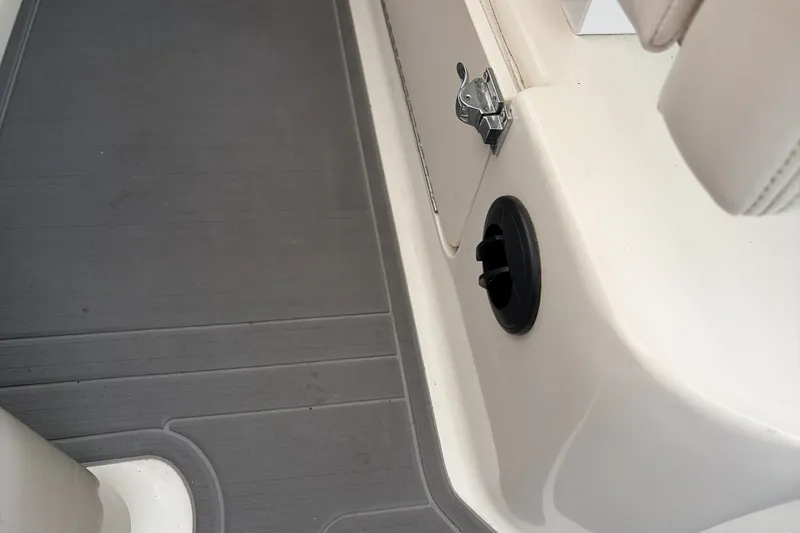 Slide: The Image of 2007 Sea Ray 290 Sundancer interior detail with gray flooring and white seating. - 23