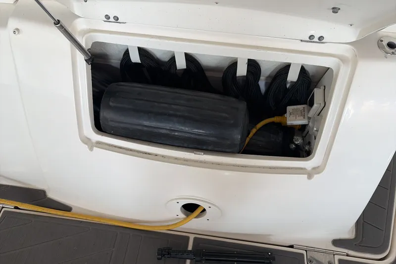 Slide: The Image of Storage compartment of a 2007 Sea Ray 290 Sundancer boat with ropes and equipment. - 16