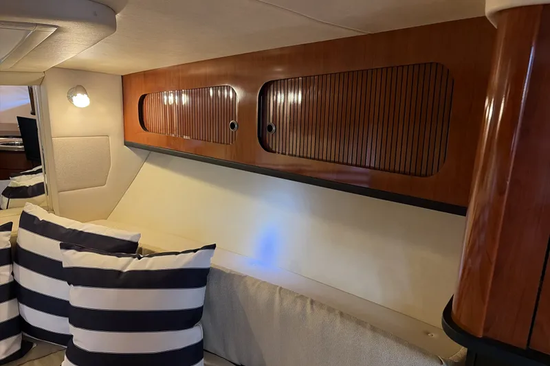 Slide: The Image of Interior of 2007 Sea Ray 290 Sundancer with striped cushions and wooden cabinetry. - 43