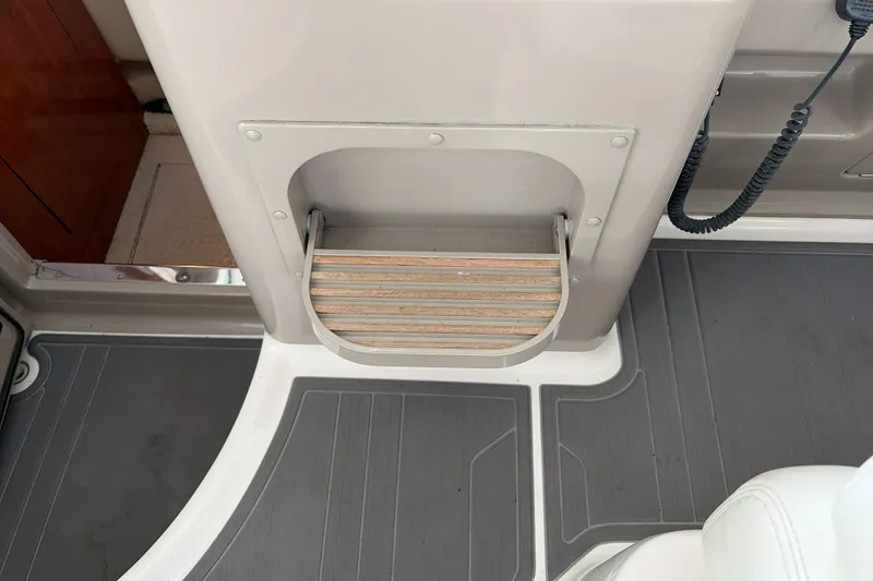 Slide: The Image of 2007 Sea Ray 290 Sundancer interior step detail with gray flooring and white seating. - 37