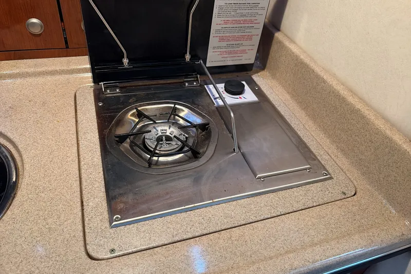 Slide: The Image of Stove in 2007 Sea Ray 290 Sundancer boat kitchen, featuring a single burner. - 27