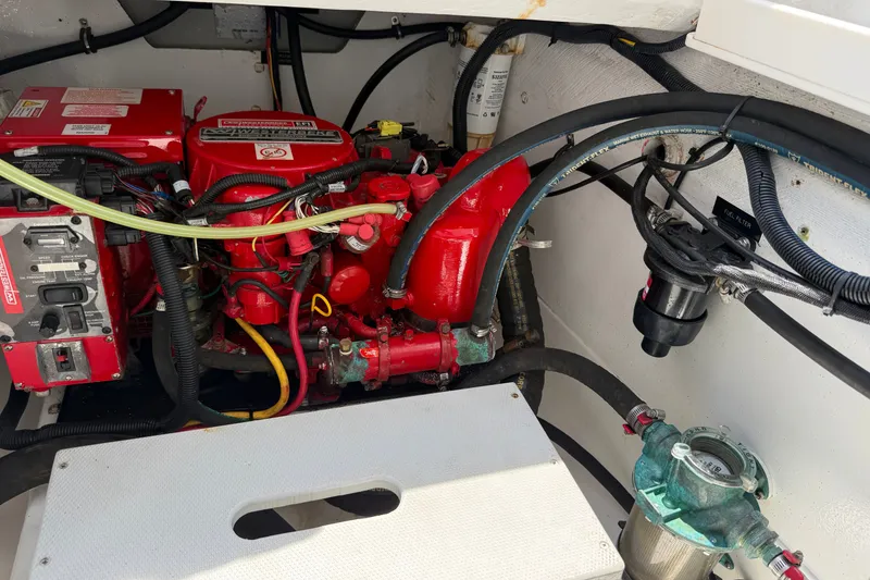 Slide: The Image of Engine compartment of a 2018 MJM 35z boat, featuring red machinery and wiring. - 39