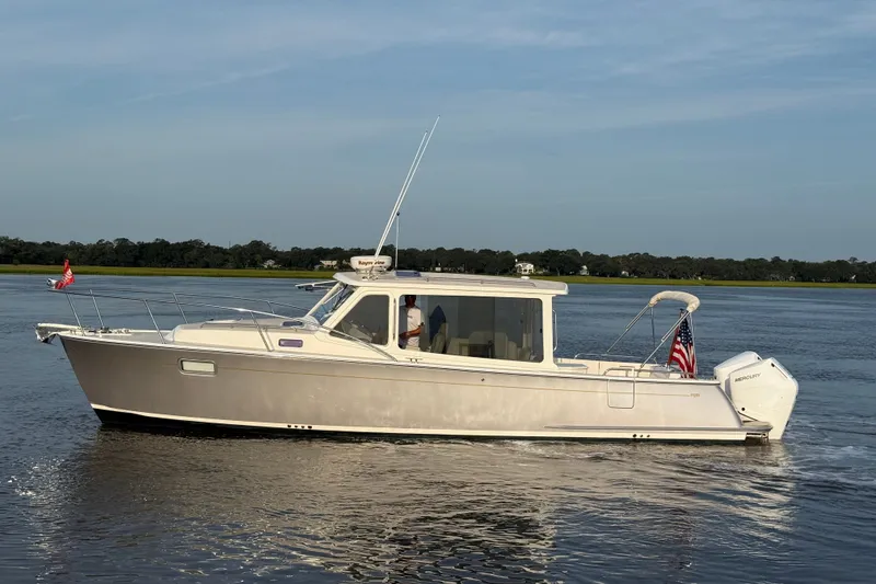 The Image of 2018 MJM 35z boat cruising on calm waters with American flag. - 0