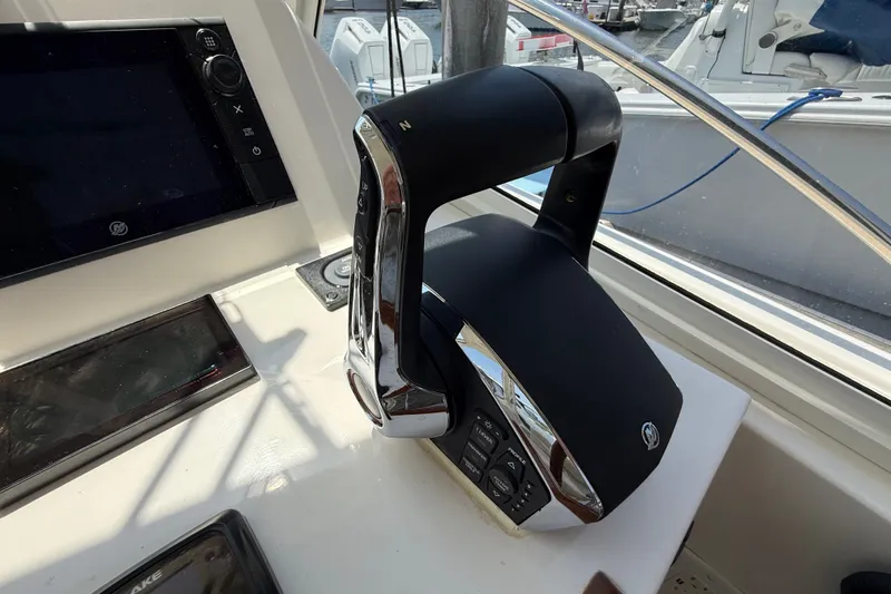 Slide: The Image of Throttle control on 2018 MJM 35z boat dashboard, featuring navigation equipment. - 20