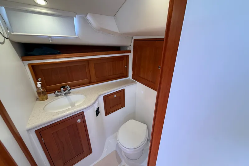 Slide: The Image of 2018 MJM 35z yacht bathroom with wooden cabinets, sink, and toilet. - 34