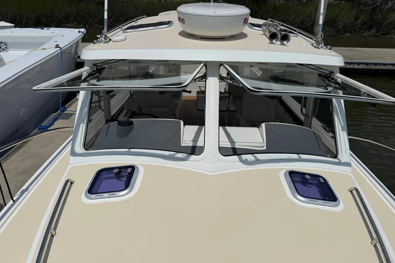 Slide: The Image of 2018 MJM 35z boat with open windows, docked at a marina. - 41