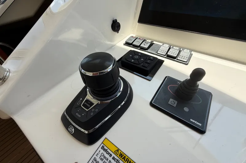 Slide: The Image of Control panel of a 2018 MJM 35z boat featuring joystick and control knobs. - 21