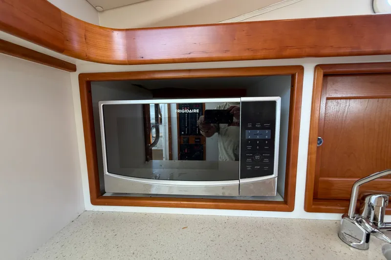 Slide: The Image of Frigidaire microwave in 2018 MJM 35z yacht kitchen with wooden cabinetry. - 33