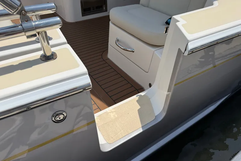 Slide: The Image of 2018 MJM 35z boat with teak deck and cushioned seating area. - 14