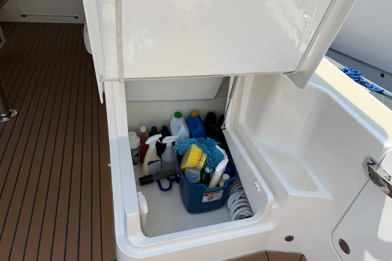 Slide: The Image of Storage compartment on 2018 MJM 35z boat with cleaning supplies and equipment. - 24