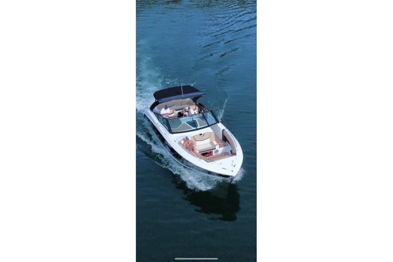 Slide: The Image of 2015 Cruisers Sport Series 328 boat cruising on calm water, aerial view. - 10