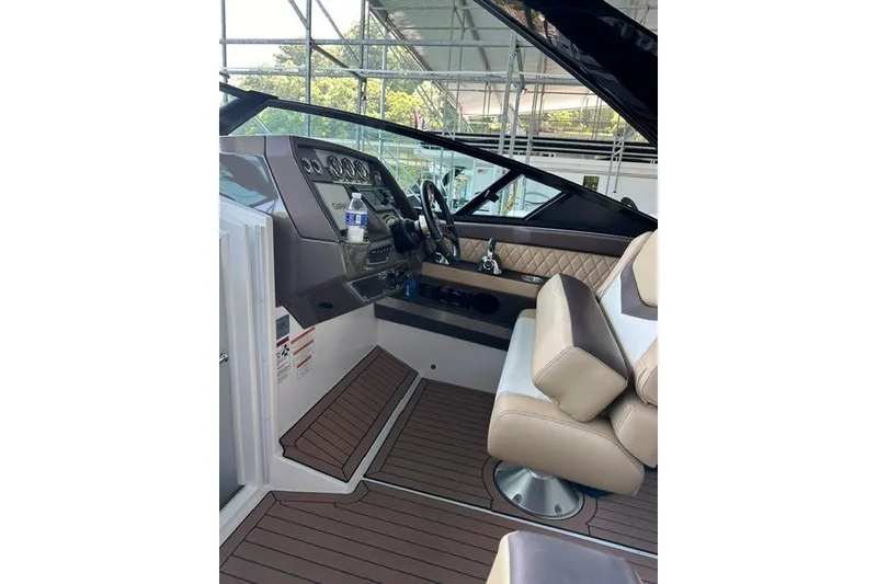 Slide: The Image of Interior of 2015 Cruisers Sport Series 328 boat with luxurious seating and modern dashboard. - 9