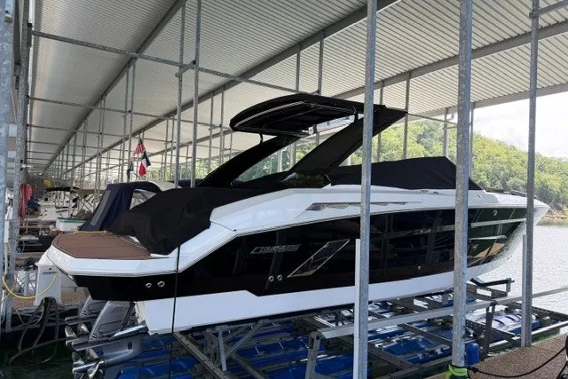 Slide: The Image of 2015 Cruisers Sport Series 328 boat docked under a covered marina. - 24