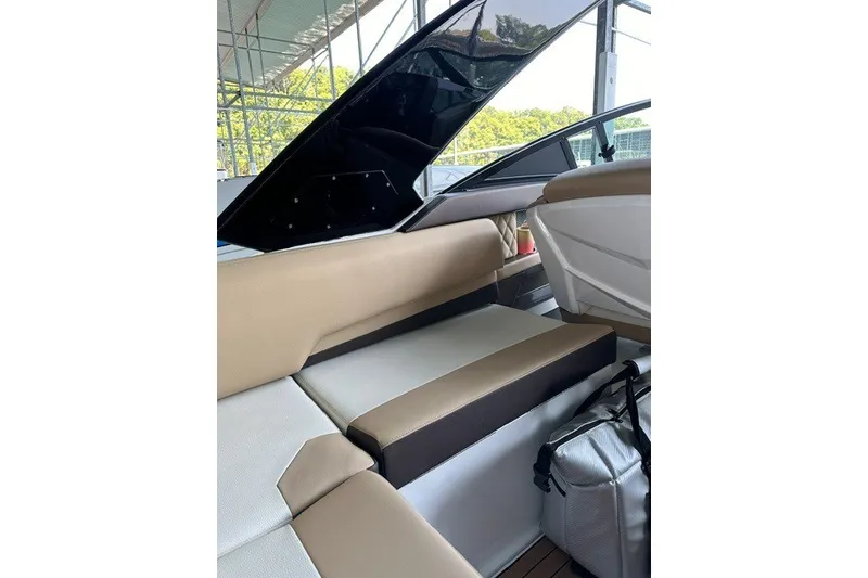 Slide: The Image of Interior of 2015 Cruisers Sport Series 328 boat with beige seating and storage area. - 34
