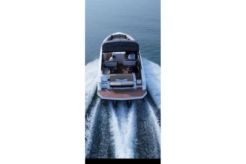 Slide: The Image of 2015 Cruisers Sport Series 328 boat cruising on open water, rear view. - 11