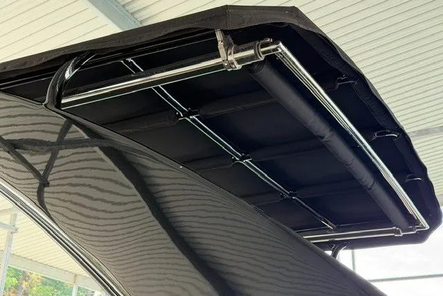 Slide: The Image of 2015 Cruisers Sport Series 328 boat canopy with sleek black design and sturdy metal frame. - 21