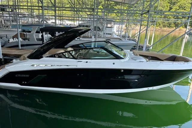 Slide: The Image of 2015 Cruisers Sport Series 328 boat docked in a marina, side view. - 3