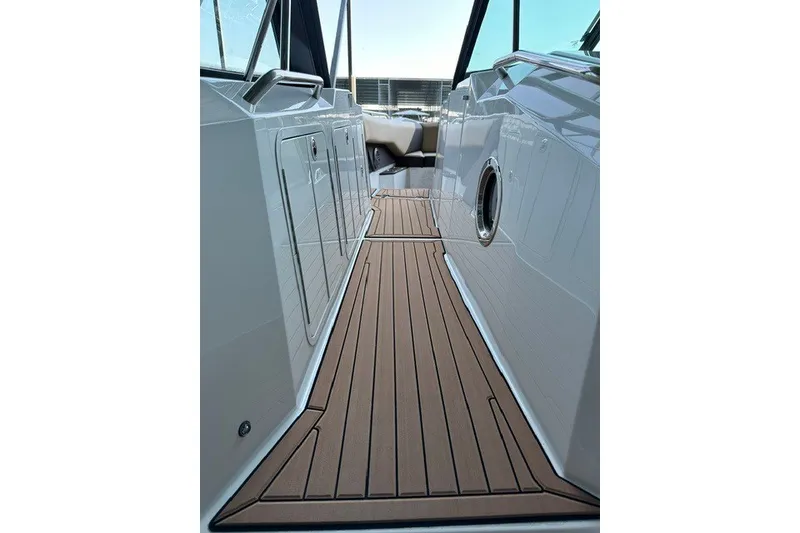 Slide: The Image of 2015 Cruisers Sport Series 328 boat deck with sleek wood finish and modern design. - 38