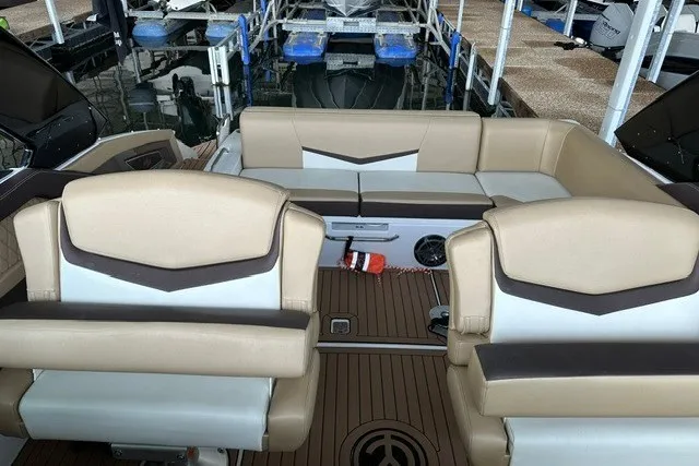 Slide: The Image of 2015 Cruisers Sport Series 328 boat interior with beige seating and wood flooring. - 37