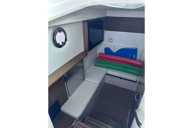 Slide: The Image of Interior of 2015 Cruisers Sport Series 328 boat with seating and colorful mats. - 43