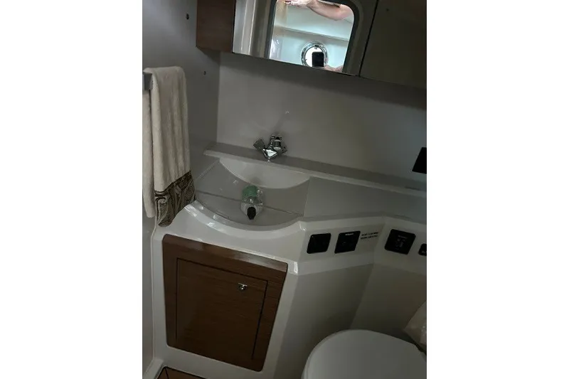 Slide: The Image of 2015 Cruisers Sport Series 328 bathroom interior with sink and mirror. - 40