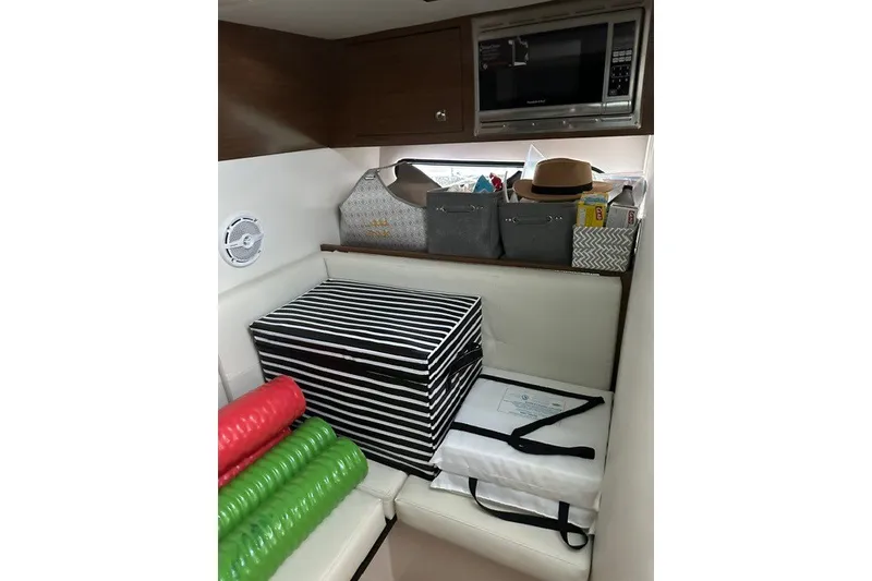 Slide: The Image of Interior of 2015 Cruisers Sport Series 328 with storage boxes and microwave. - 42