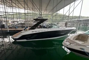 Slide: The Image of 2015 Cruisers Sport Series 328 boat docked in a marina under a canopy. - 1
