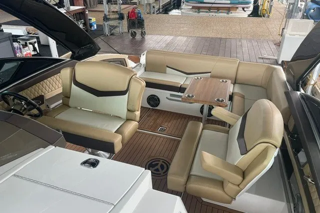 Slide: The Image of Luxurious 2015 Cruisers Sport Series 328 boat interior with beige seating and wooden flooring. - 19