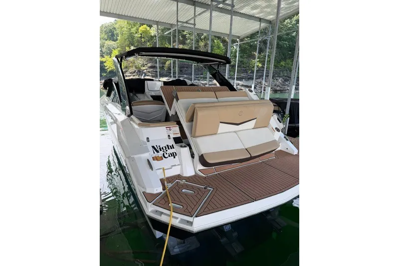 Slide: The Image of 2015 Cruisers Sport Series 328 boat docked, featuring tan seating and sleek design. - 30