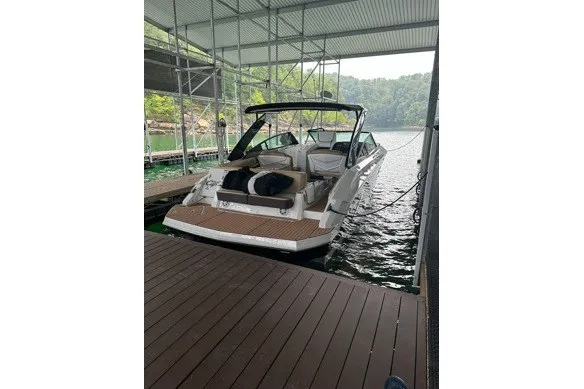 Slide: The Image of 2015 Cruisers Sport Series 328 boat docked under a covered marina. - 13