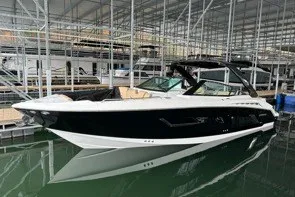 Slide: The Image of 2015 Cruisers Sport Series 328 boat docked in a marina. - 2