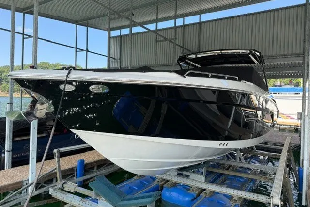 Slide: The Image of 2015 Cruisers Sport Series 328 boat docked in a covered marina. - 5