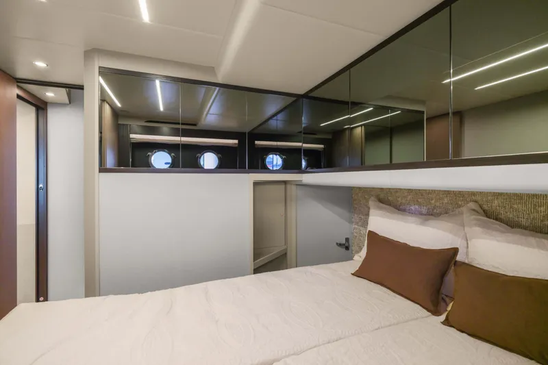 Slide: The Image of Luxurious bedroom interior of 2026 Absolute 52 Fly yacht with modern design and porthole windows. - 53